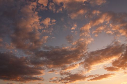 Capture of a dramatic sunset with vivid orange and purple clouds filling the sky.