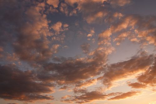 Free Capture of a dramatic sunset with vivid orange and purple clouds filling the sky. Stock Photo