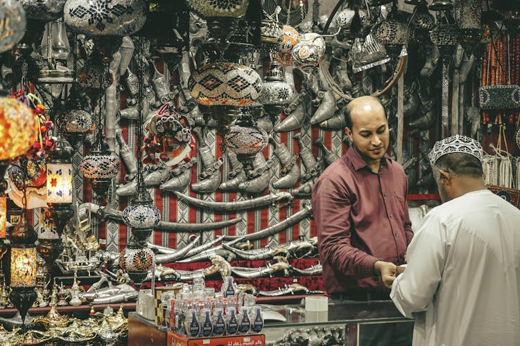 Oriental Souvenir Shop Counter With Seller And Customer