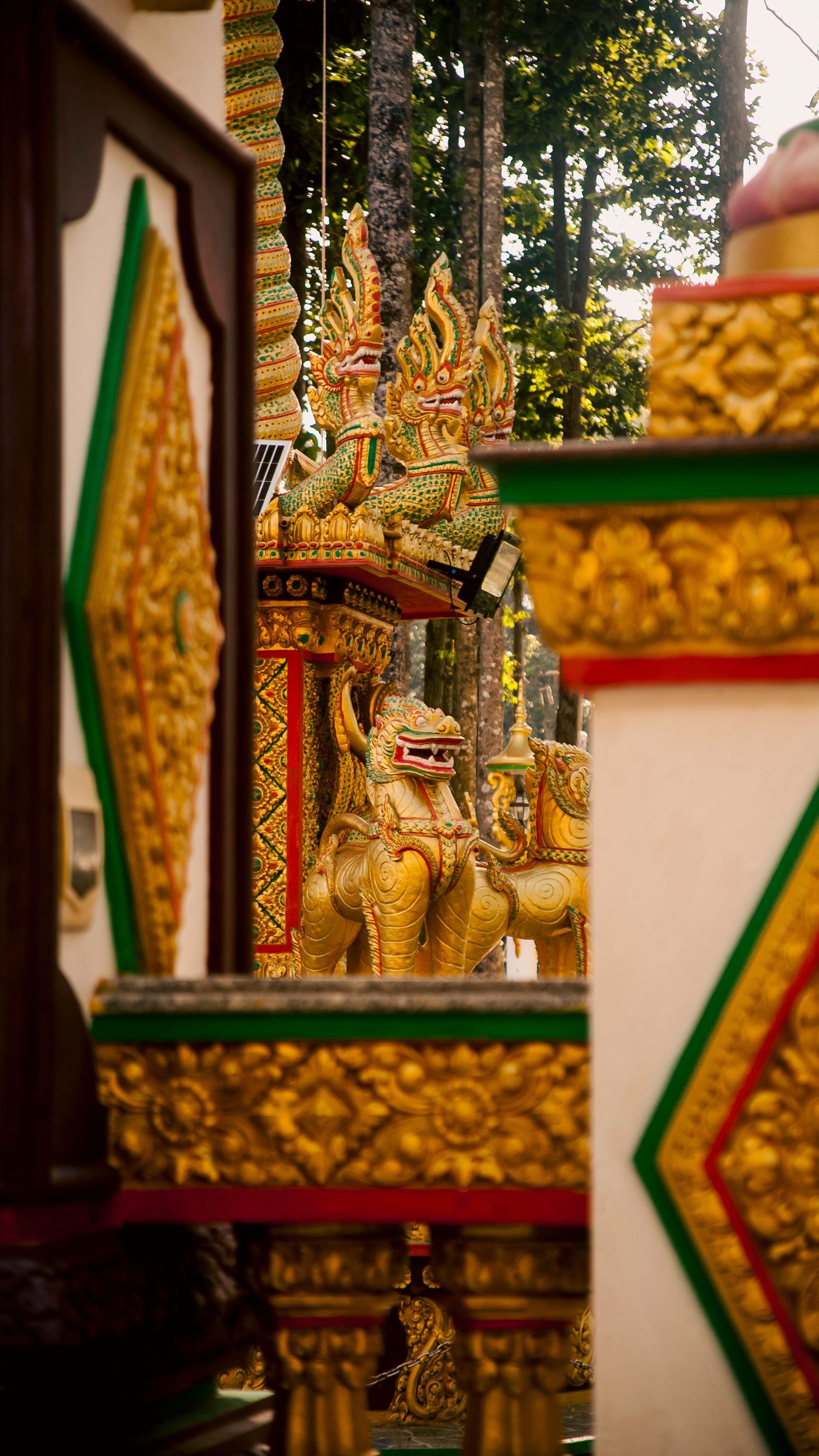 Close-up of vibrant ornate temple decorations in Vinh Long, Vietnam.