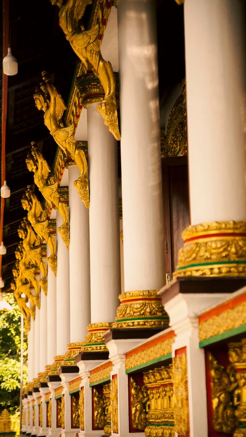 Free Golden details and pillars adorn a temple facade in Nguyet Hoa, Vinh Long, Vietnam, showcasing traditional architecture. Stock Photo