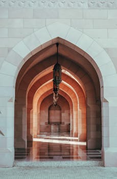 Traditional Islamic archway in Muscat, Oman, showcasing intricate architecture.