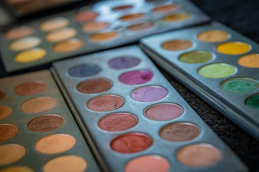 Close-up of vibrant makeup palettes showcasing diverse eyeshadow shades.