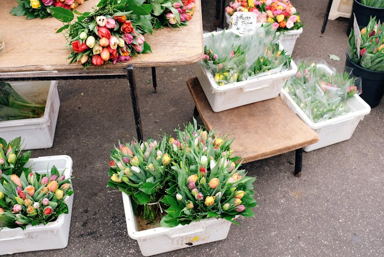 Fresh Flowers In White Plastic Boxes On Stall In Street Market