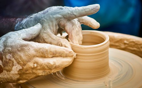 Free Close-up of hands molding clay on a pottery wheel, showcasing the art of ceramics. Stock Photo