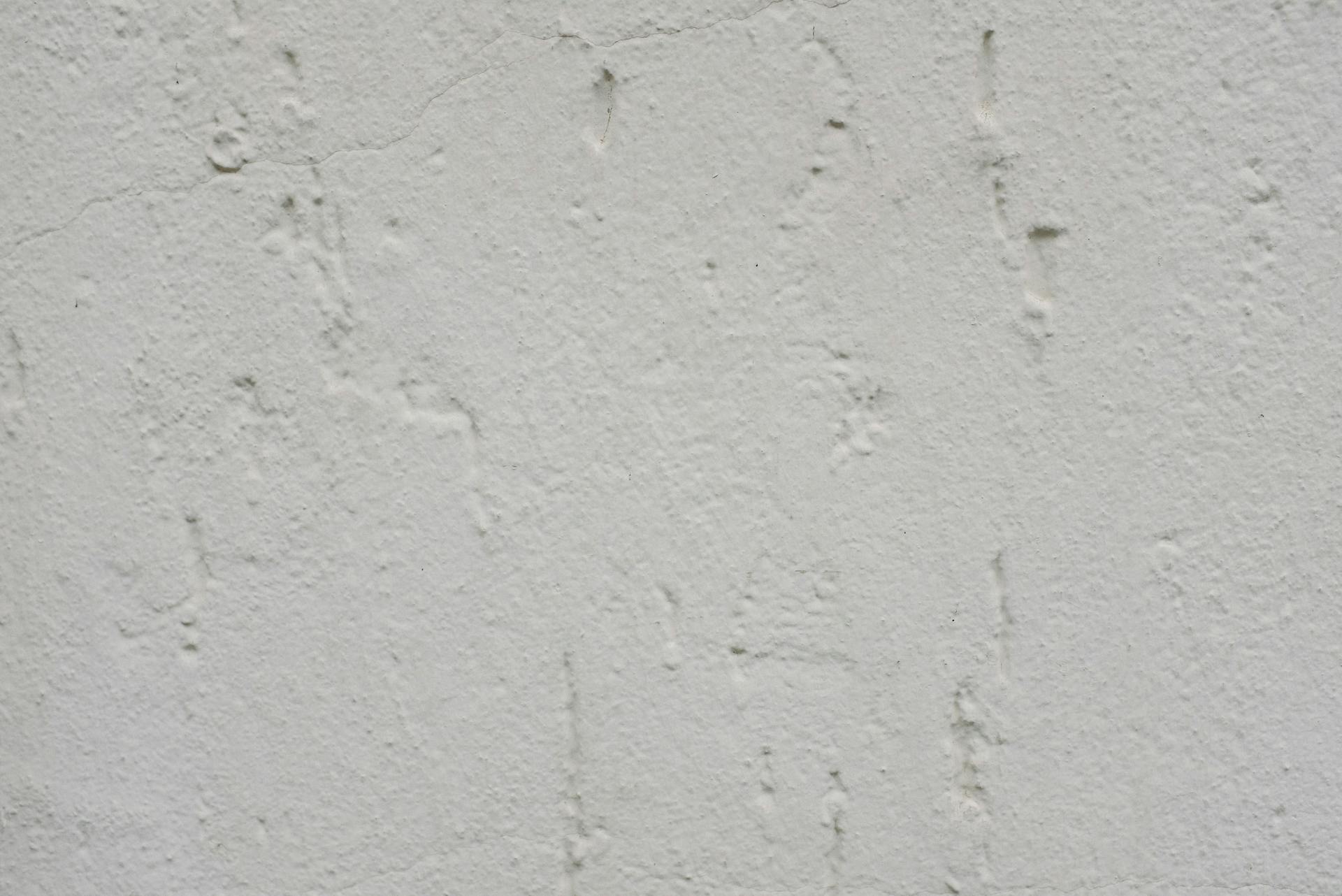 Closeup background of white plaster wall surface with uneven texture