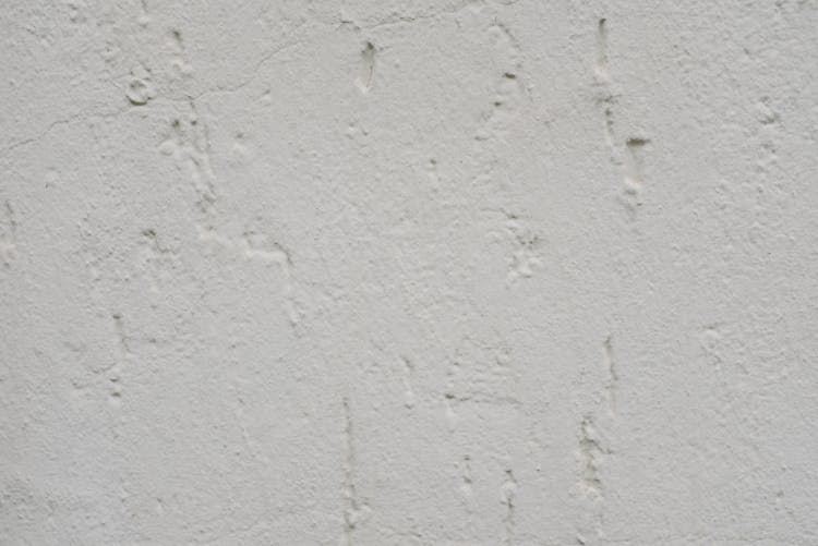 Shabby Concrete Wall Painted In White