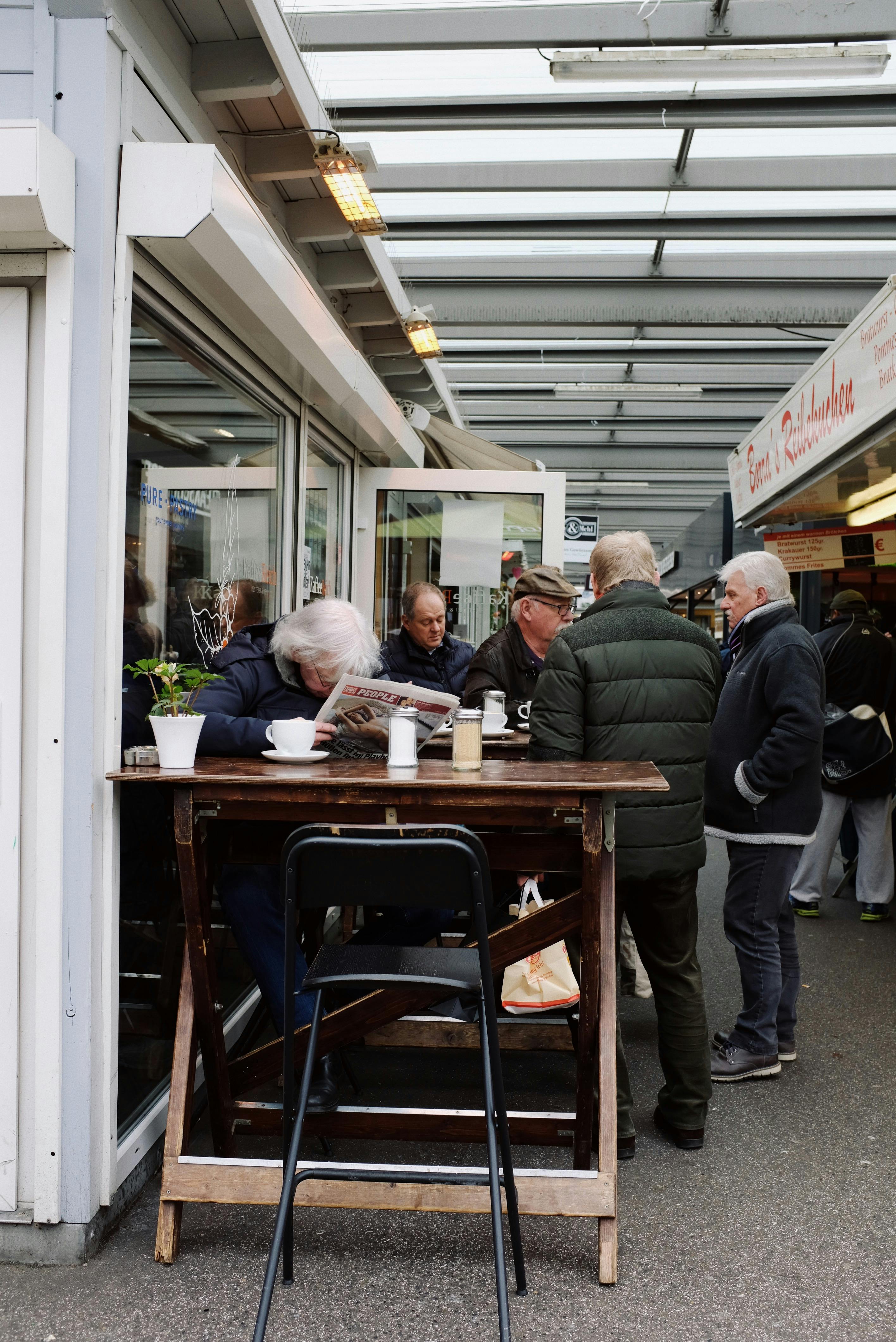Group of people gathering in outdoor cafeteria in modern ...