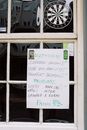 Blackboard with timetable hanging on entrance of cafe