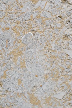 Close-up of a detailed textured concrete surface with earth tones.
