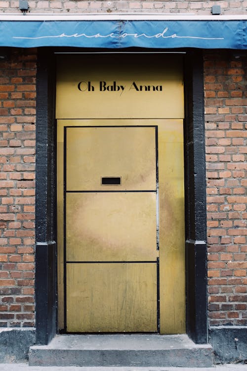 Beige Wooden Door on Brown Brick Wall