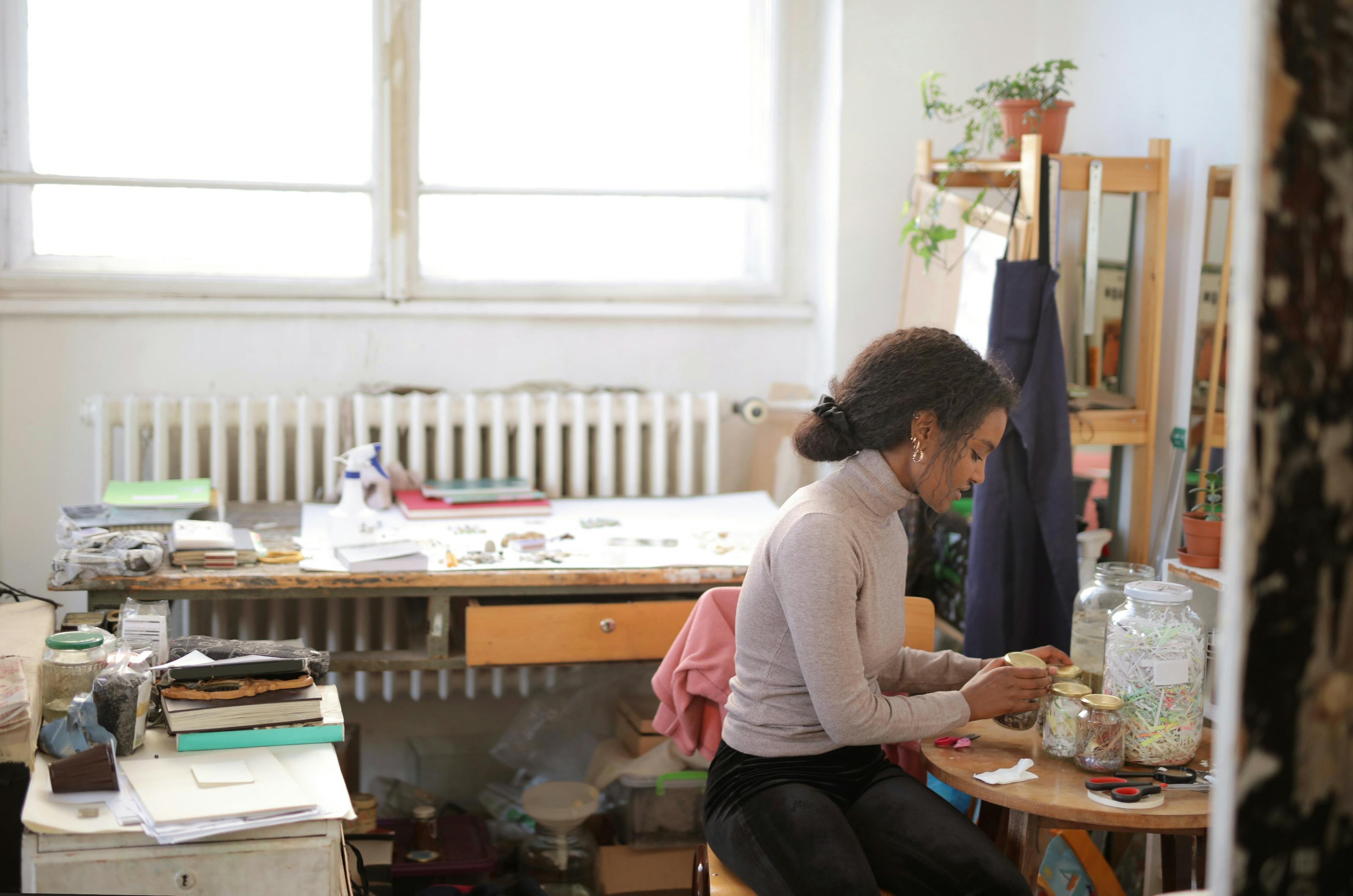 Woman in Long Sleeve Shirt Sitting on Chair Inside A Room