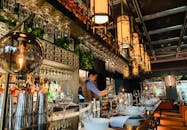 Bartender working at bar counter in oriental restaurant