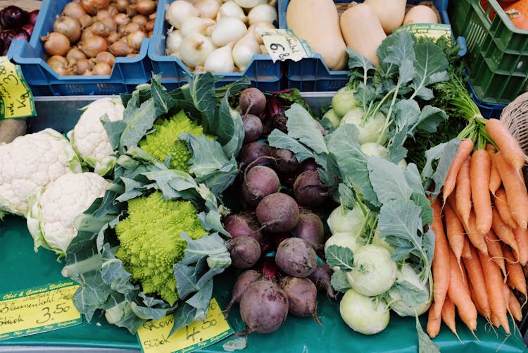 Variety Of Vegetables On Blue Plastic Crates And Table