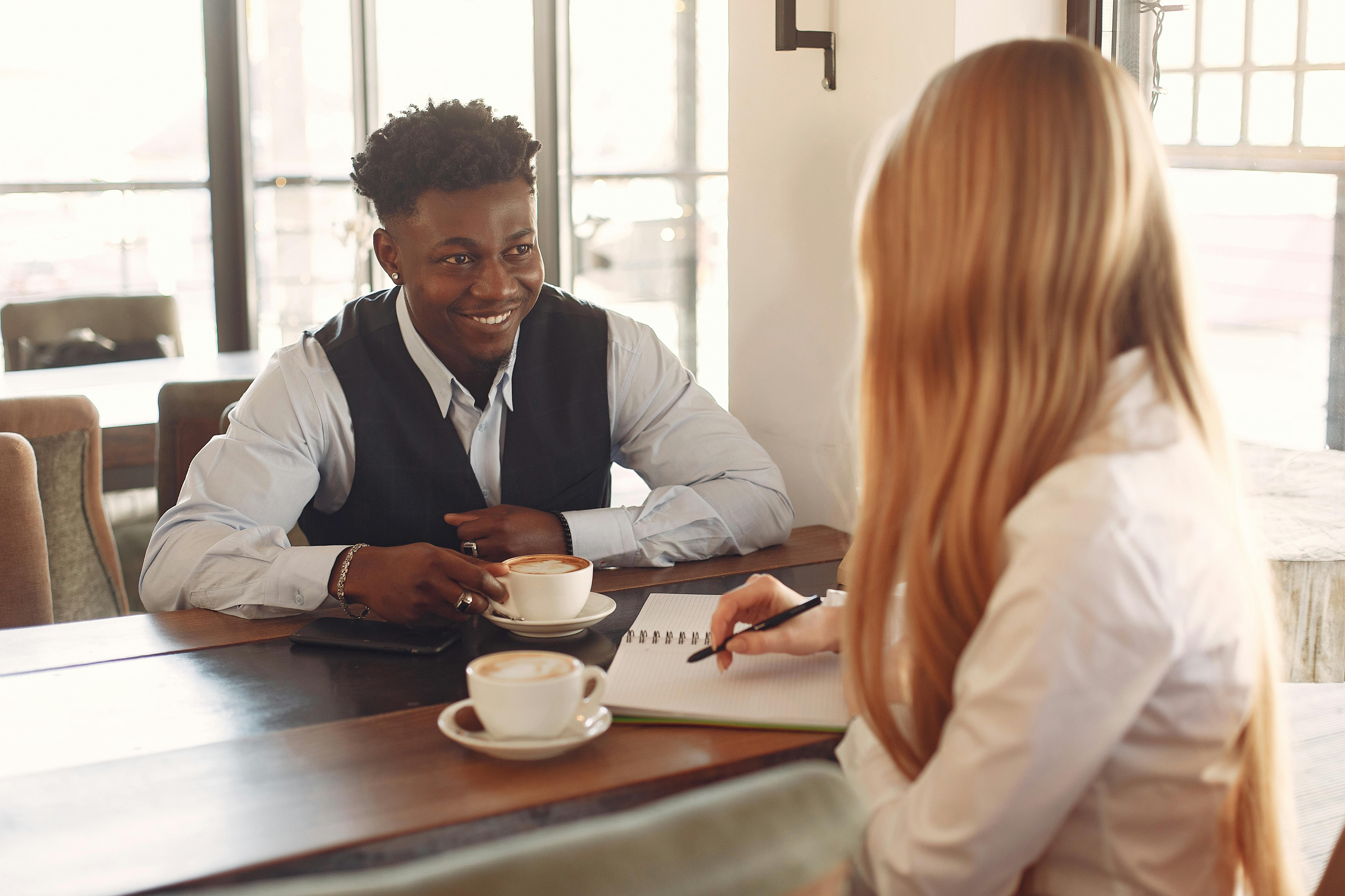 Two People Having Coffee While Talking · Free Stock Photo