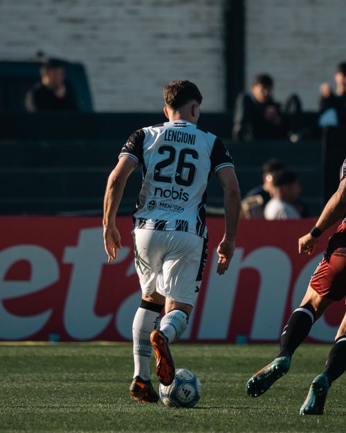 Free Players in action during an outdoor soccer match, with intensity and focus. Stock Photo