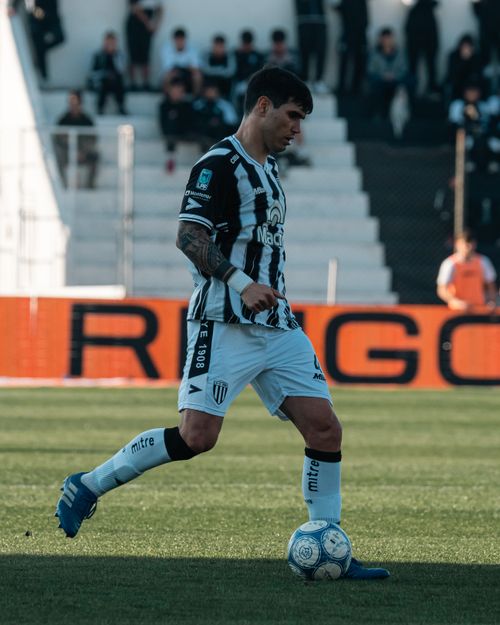Free Soccer player in action during a match on a clear day, displaying skill and focus. Stock Photo