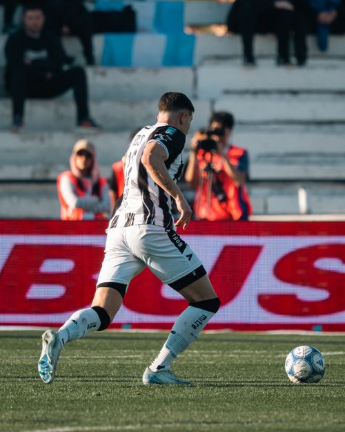 Free Male soccer player dribbling the ball during a competitive match outdoors. Stock Photo