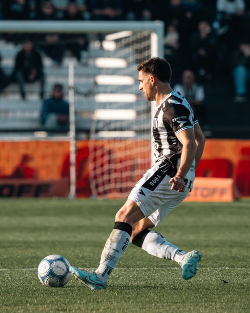 Free Professional soccer player in mid-action on a sunny day game. Stock Photo