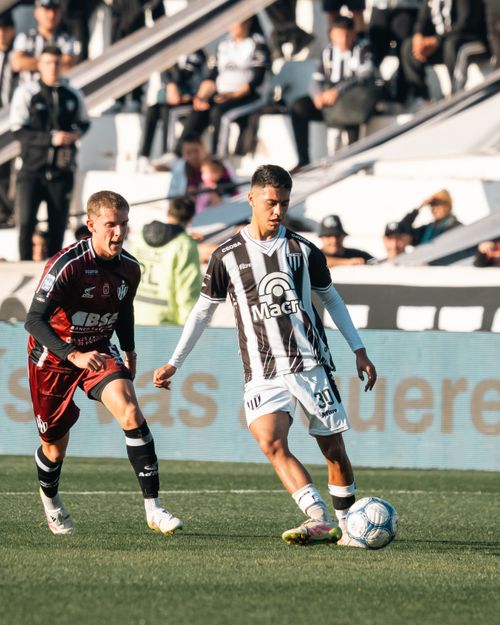 Free Dynamic action shot of two soccer players competing in a match on the field, showcasing skill and athleticism. Stock Photo