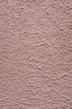 Close-up view of a textured pink concrete wall, perfect for backgrounds.
