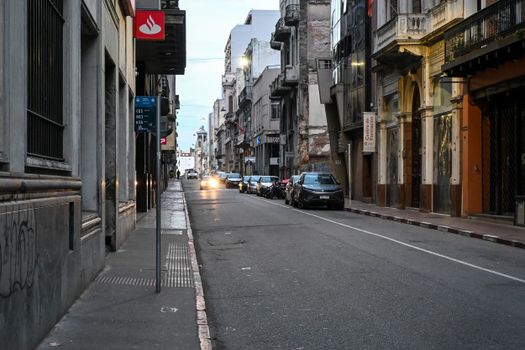Empty street in Montevideo, Uruguay at dusk, showcasing historic architecture and urban scenery.