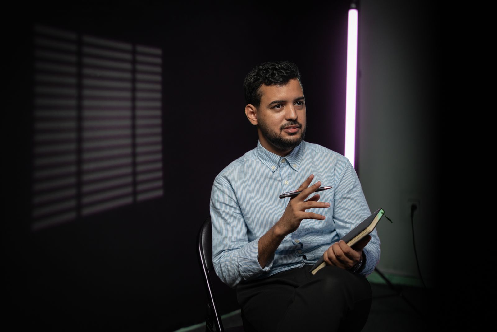 A founder talking to camera on a dark set — photo by Ben Khatry on Pexels