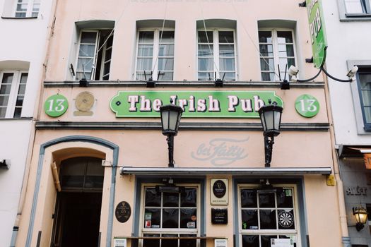 Front view of a classic Irish pub with vintage architecture in an urban street setting.