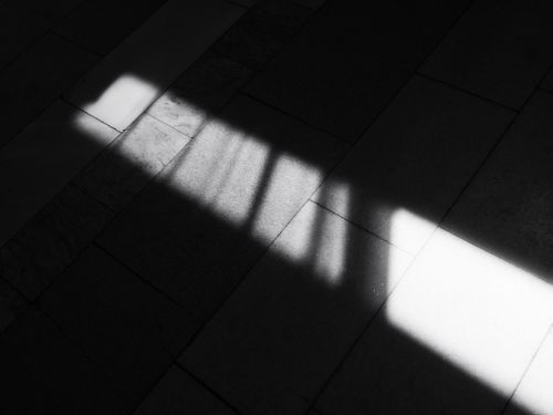 Free Black and white photo capturing shadows on a tiled floor in Bardejov, Slovakia. Stock Photo