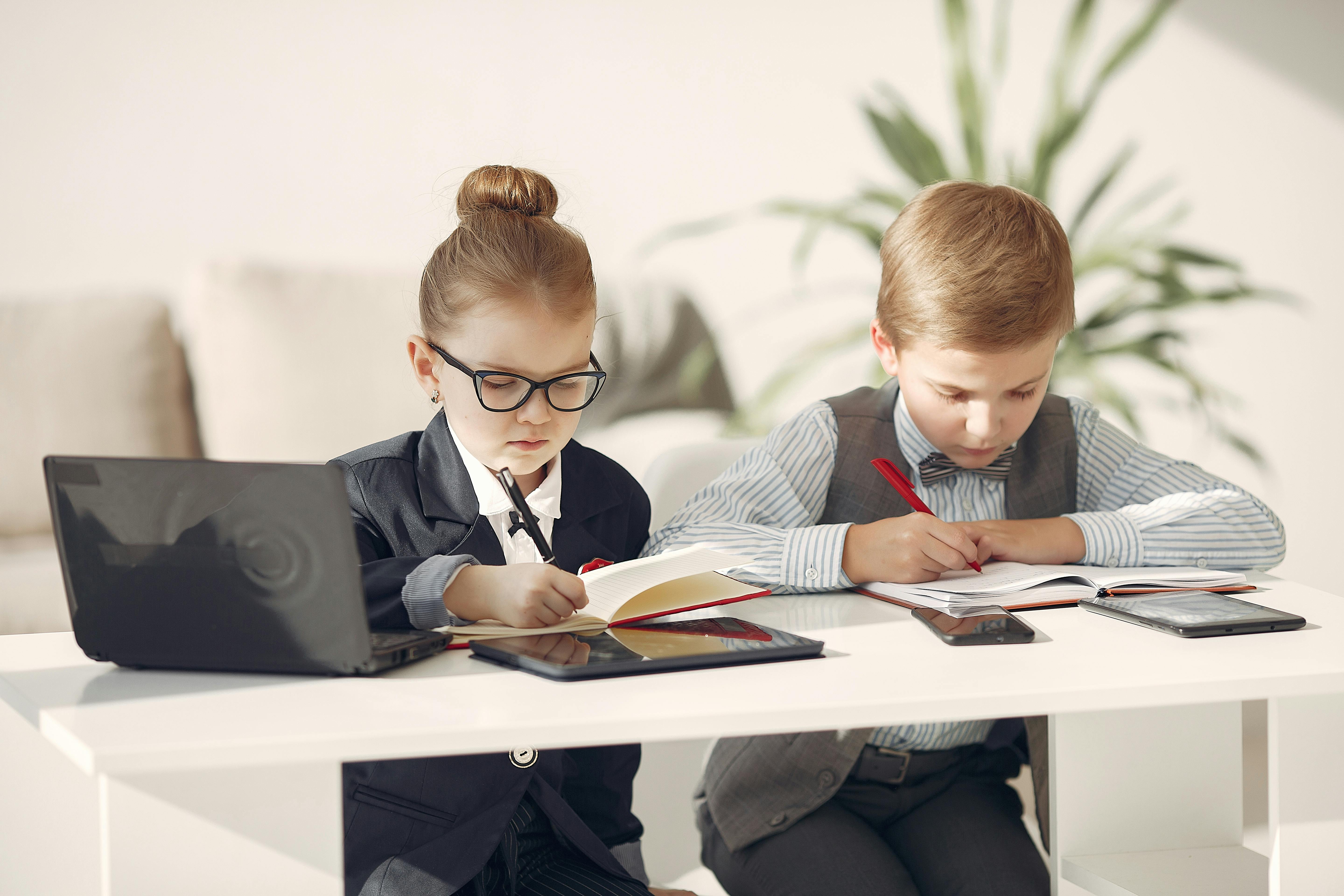 focused preschool managers taking notes in organizers during working day