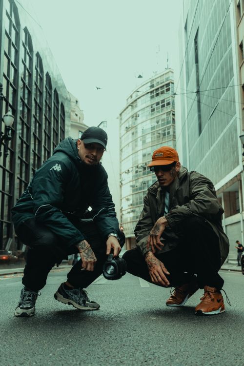 Free Two men posing urban style in the streets of São Paulo, showcasing street fashion and attitude. Stock Photo