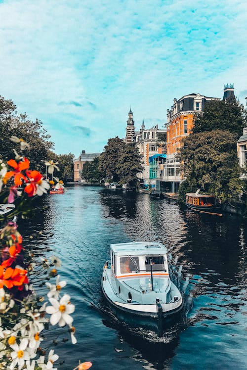 Boat floating on calm city canal