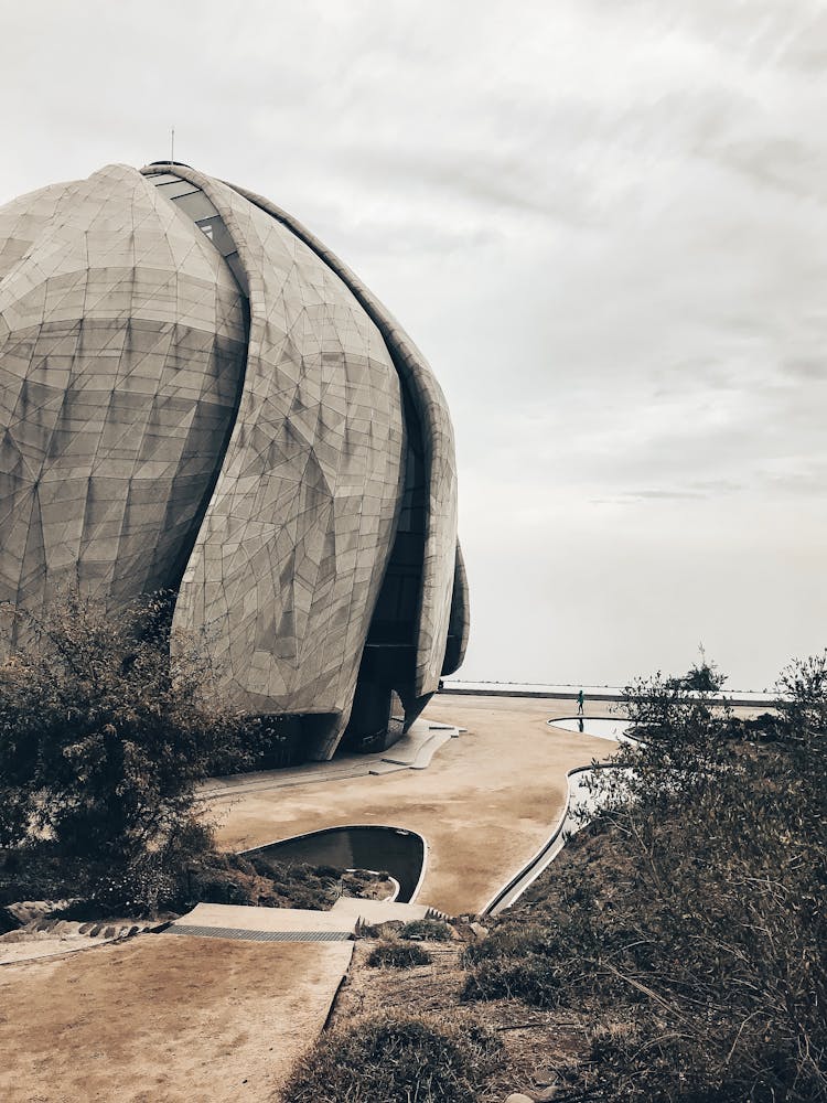 Modern Futuristic Building Of Sphere Shape Against Gray Sky