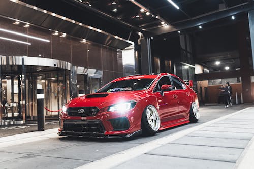 Red Subaru Parked in Front of Building