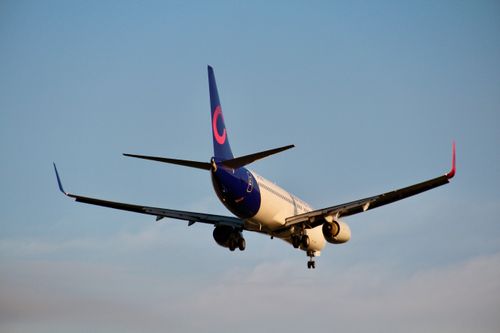 Free A commercial jet in flight during the day with clear blue skies, showcasing aviation and travel. Stock Photo