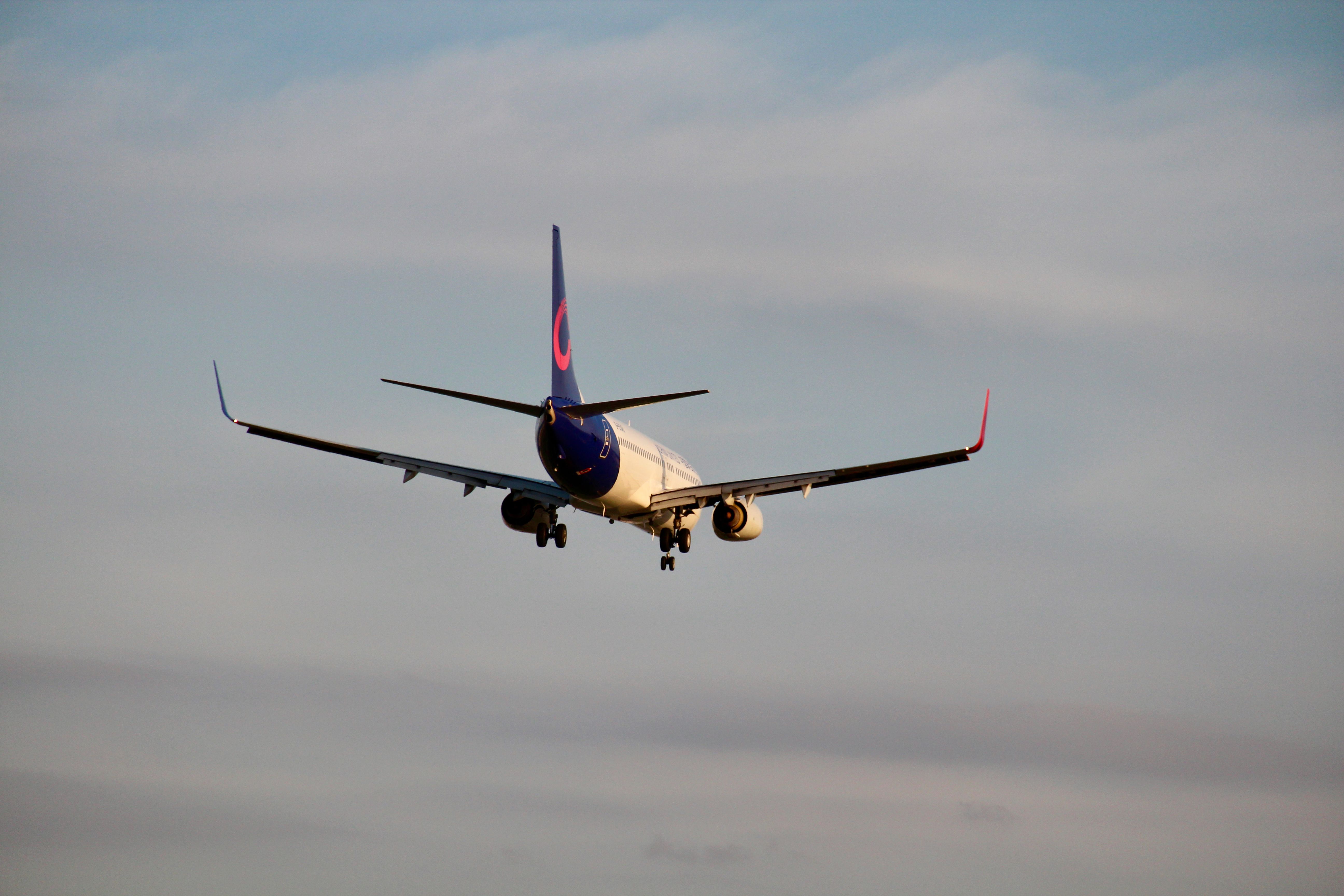 Aircraft captured mid-flight approaching landing, showcasing aviation dynamics in clear skies.