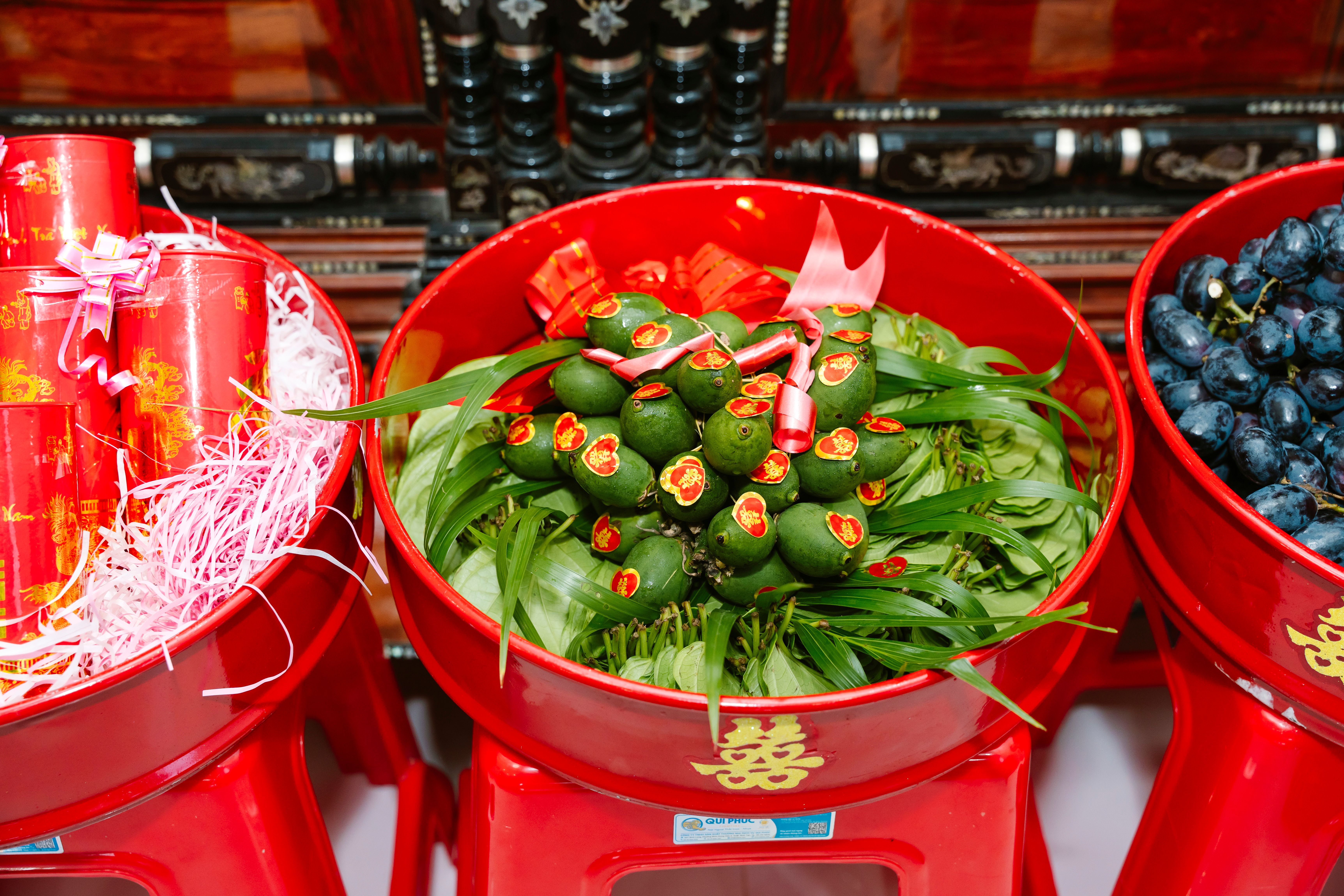 Traditional wedding offerings in red trays showcasing cultural significance in Ho Chi Minh City.