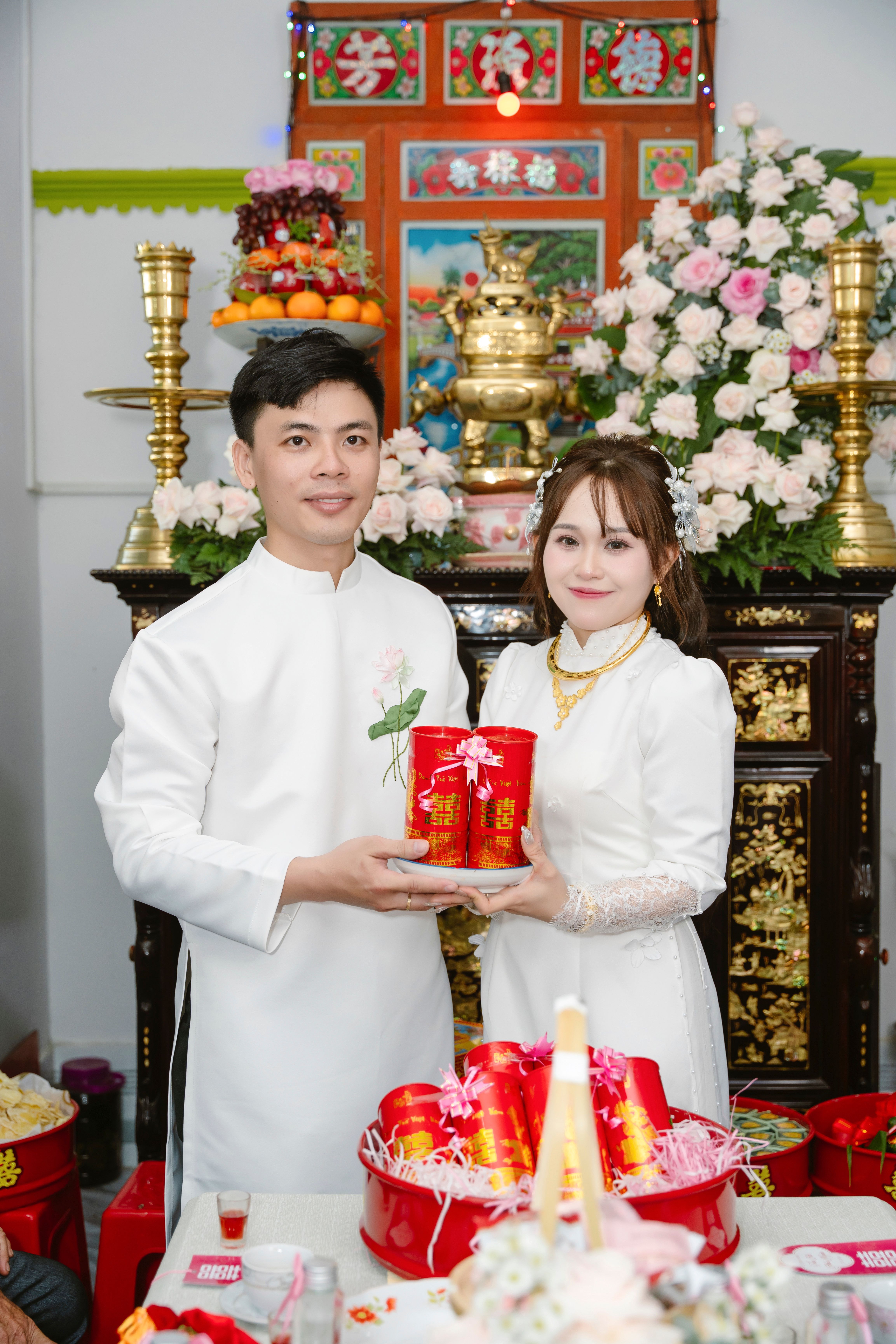 A couple in traditional attire during a Vietnamese wedding ceremony in Ho Chi Minh City.
