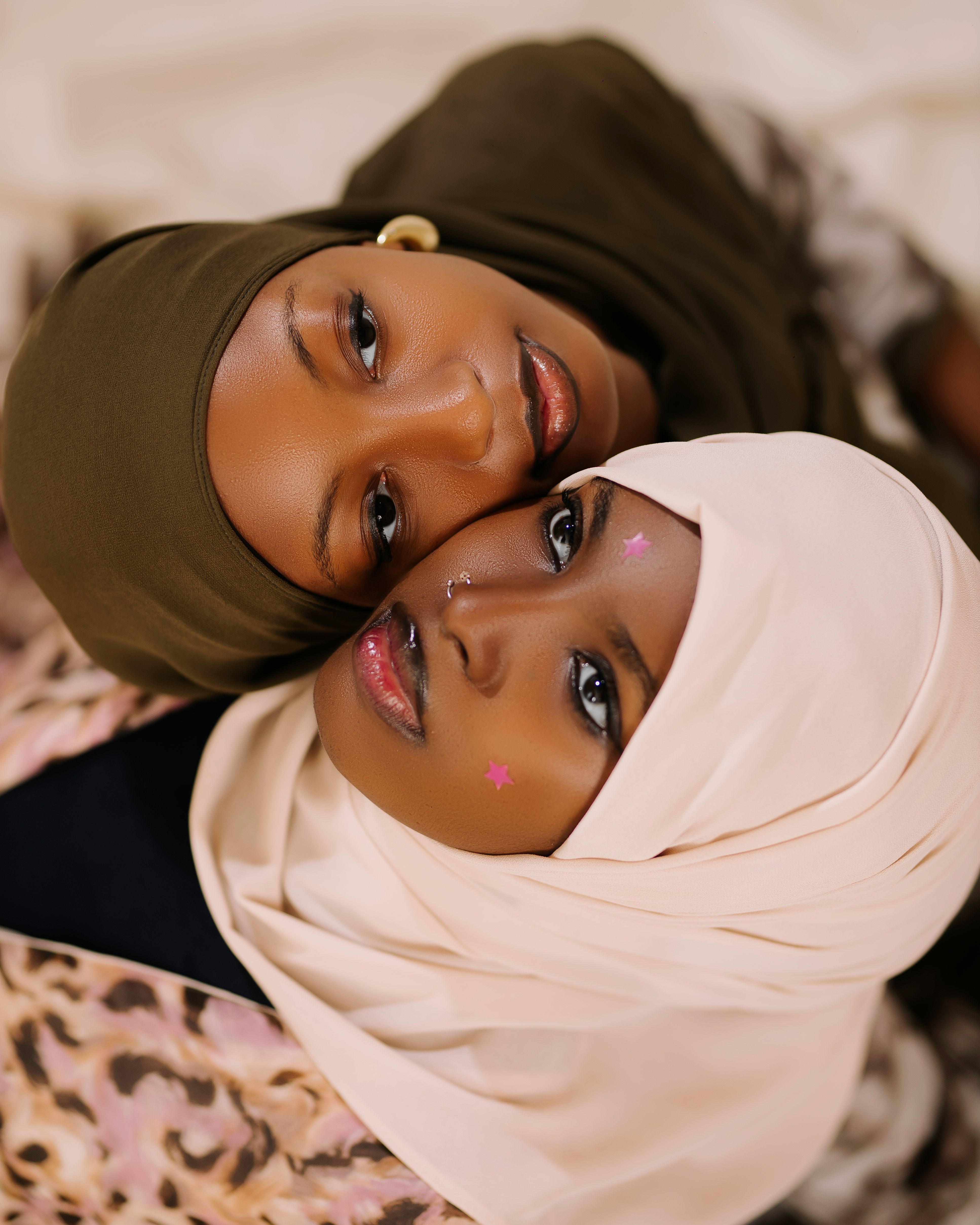 Intimate portrait of two women embracing traditional fashion in Nigeria.