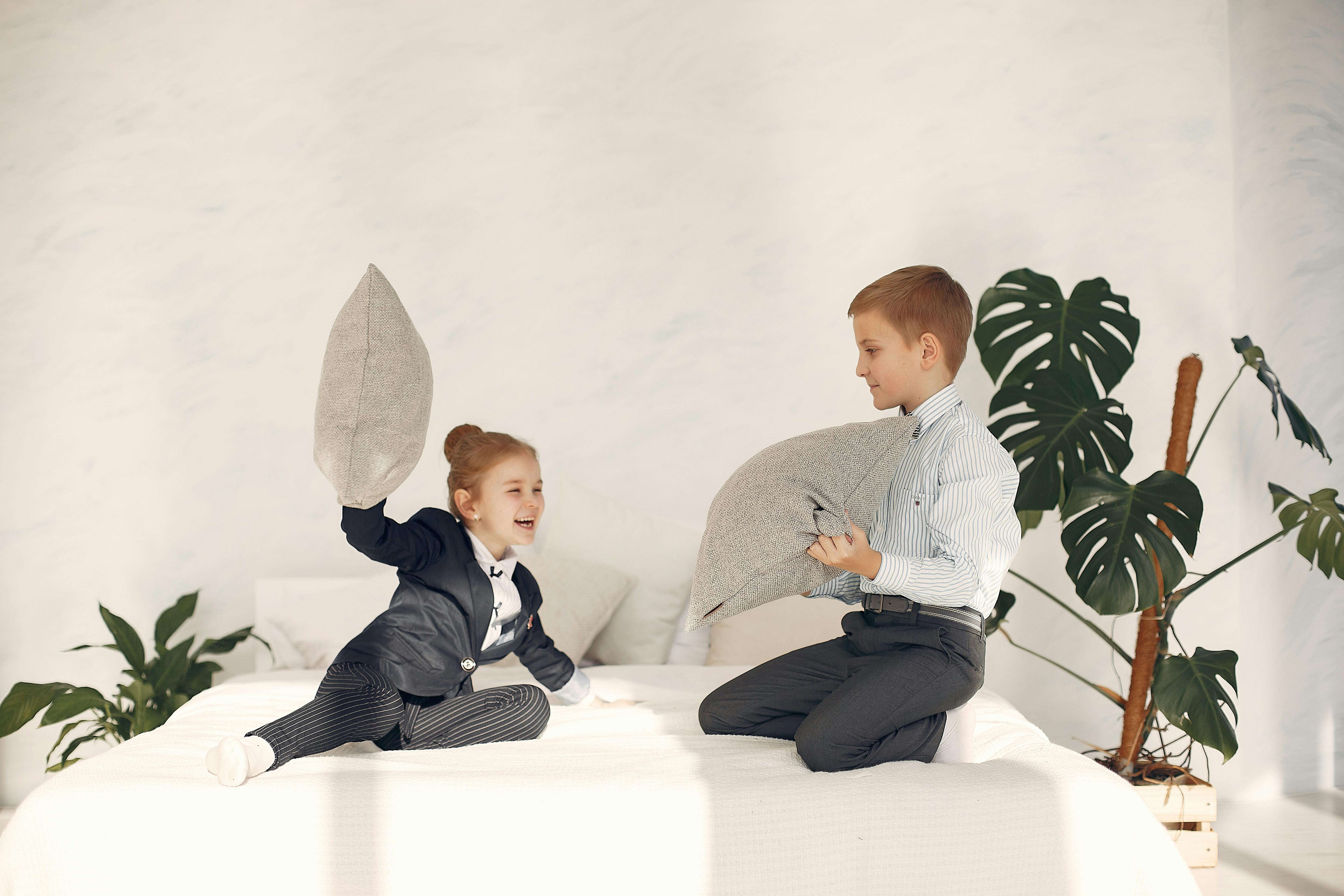 happy little kids having fun together during pillow fight game