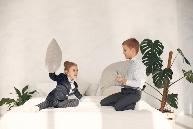 Happy Little Kids Having Fun Together During Pillow Fight Game