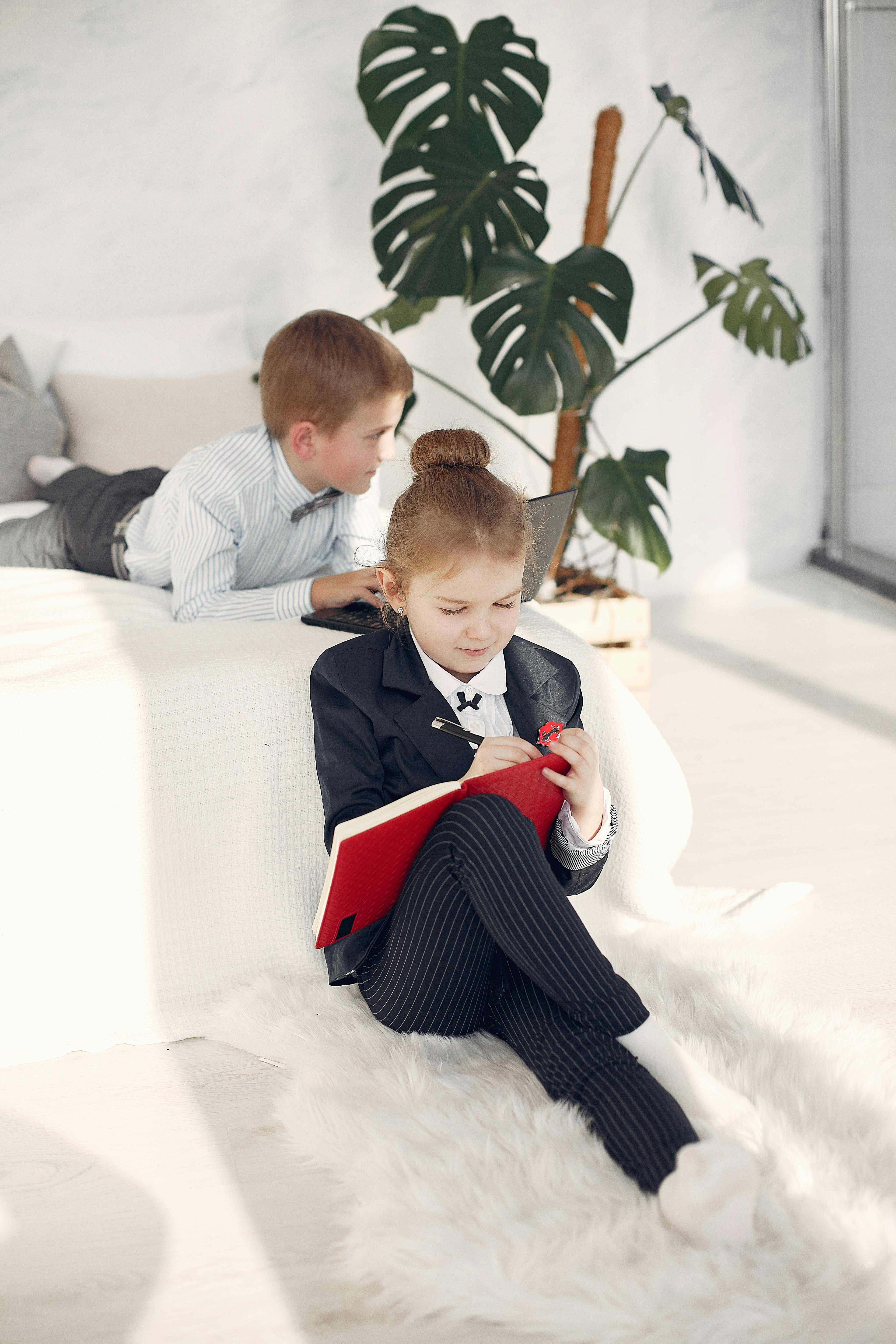 Positive little business children during remote job at home free