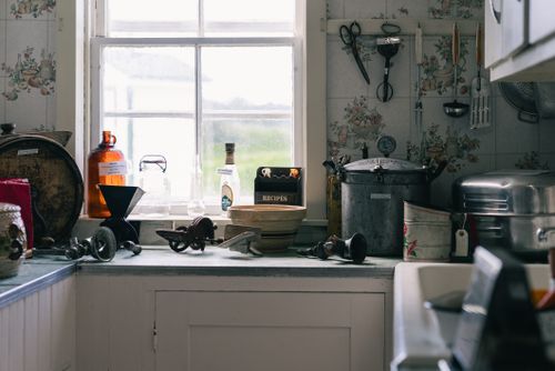 Free A quaint and nostalgic vintage kitchen showcasing rustic cookware and decor. Stock Photo