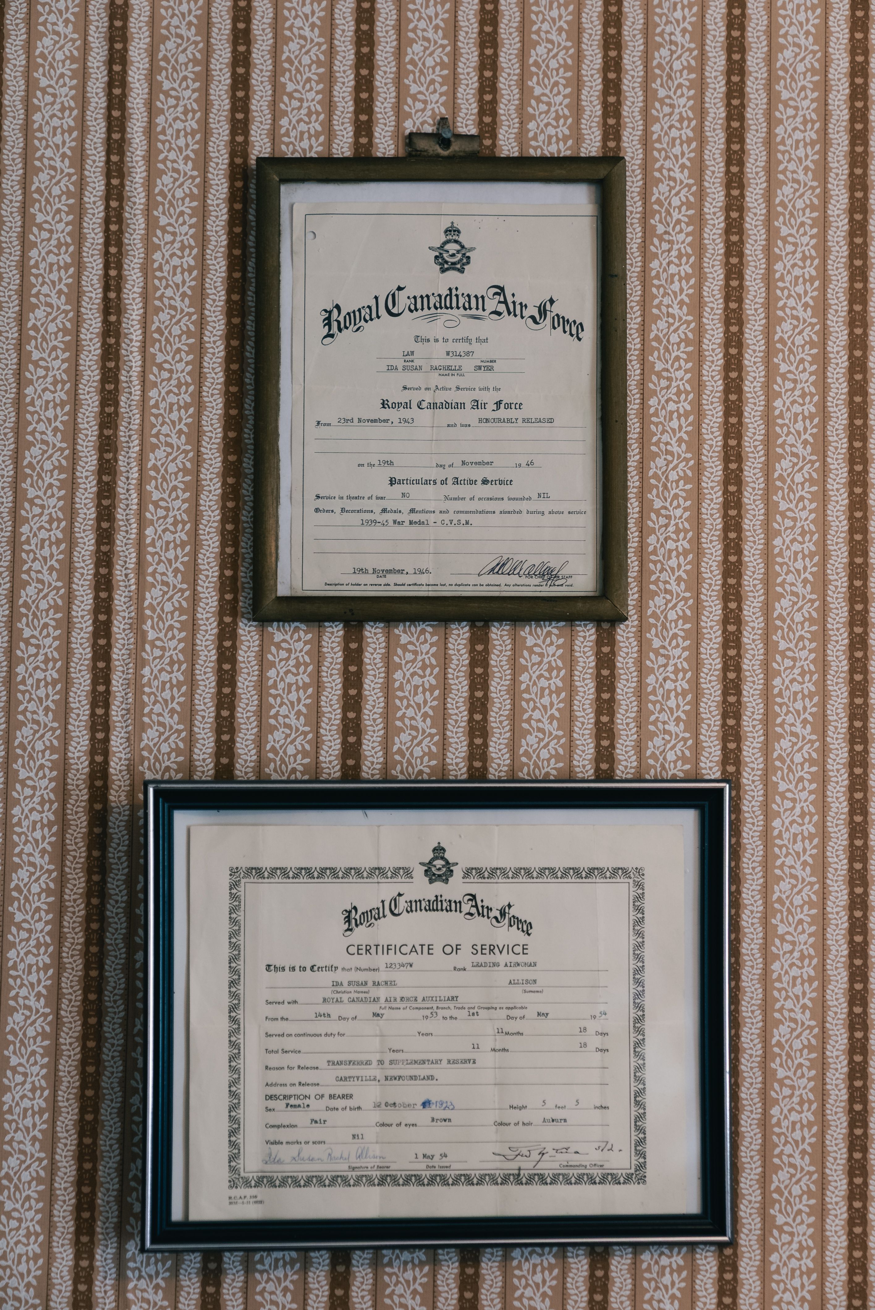 A hand holding a pen over a printed stock certificate