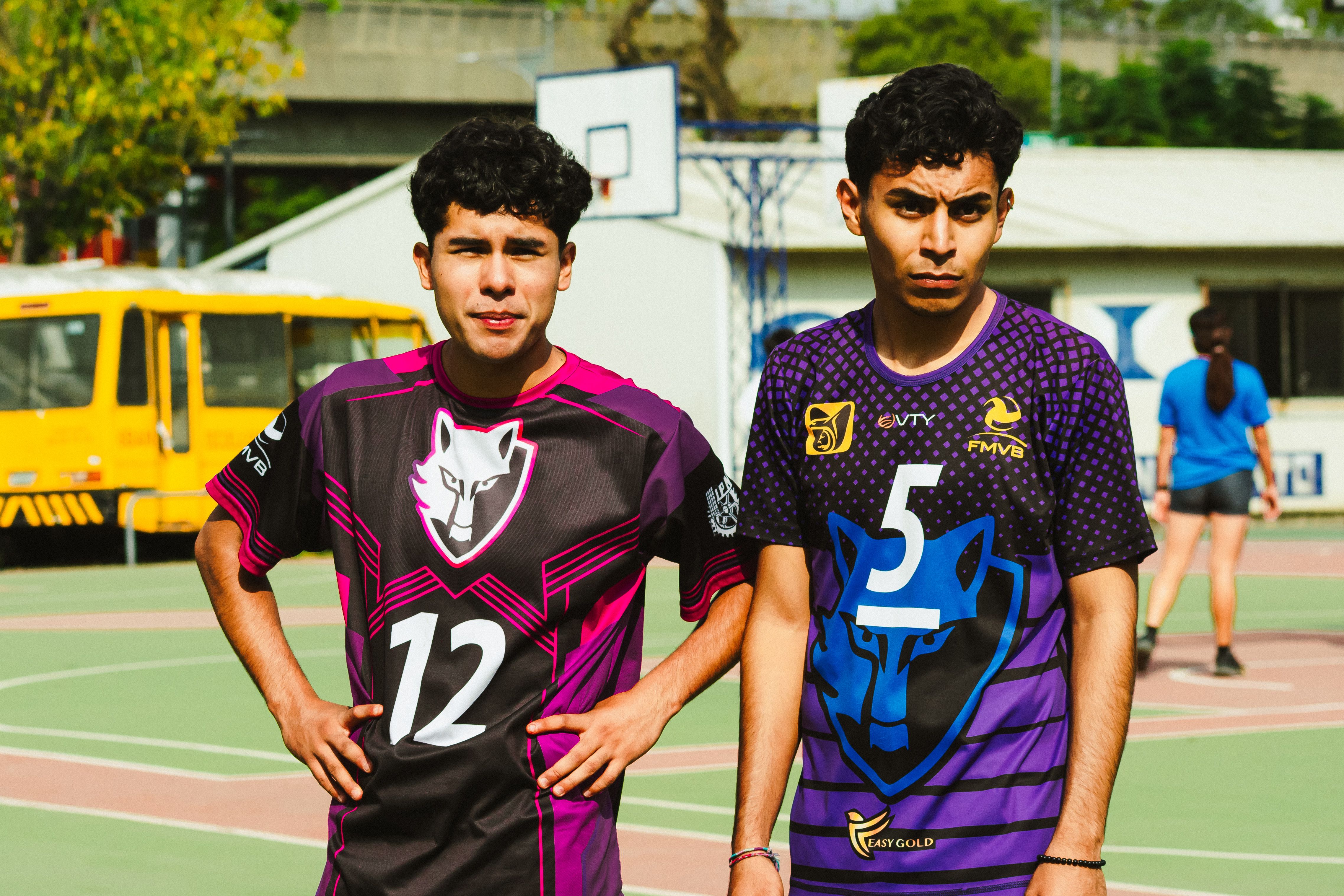 Two young volleyball players stand confidently on an outdoor court in Mexico City.