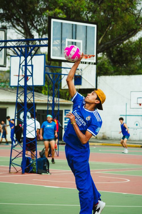 Free Young athletes playing a lively basketball game on an outdoor court in Mexico City. Stock Photo