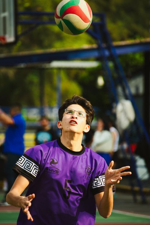 Free A young male volleyball player prepares to make a play. Captured outdoors during a sports match in Mexico City. Stock Photo