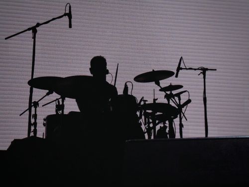 Free Dramatic silhouette of a drummer performing on stage, highlighting music and performance themes. Stock Photo