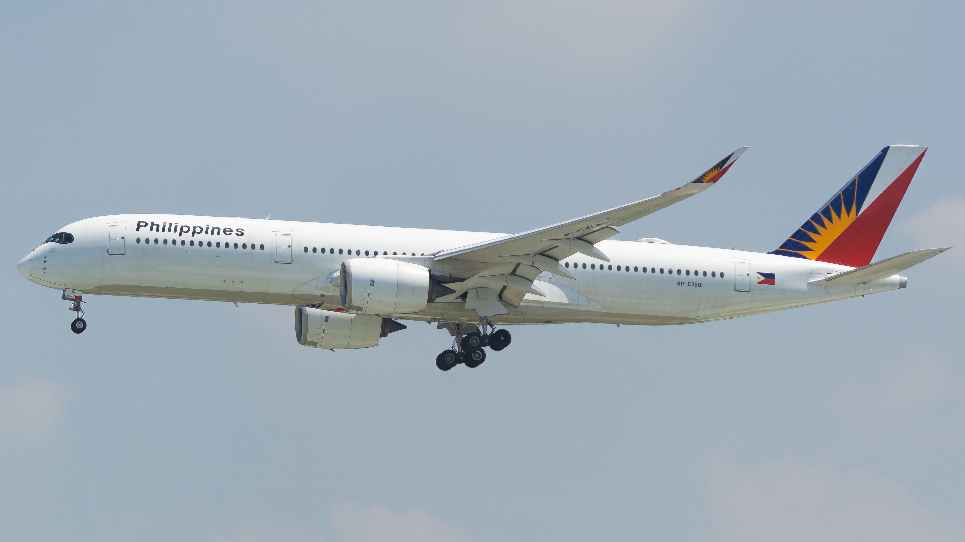 A Philippine Airlines Airbus A350 captured in-flight against a clear sky, showcasing its sleek design.
