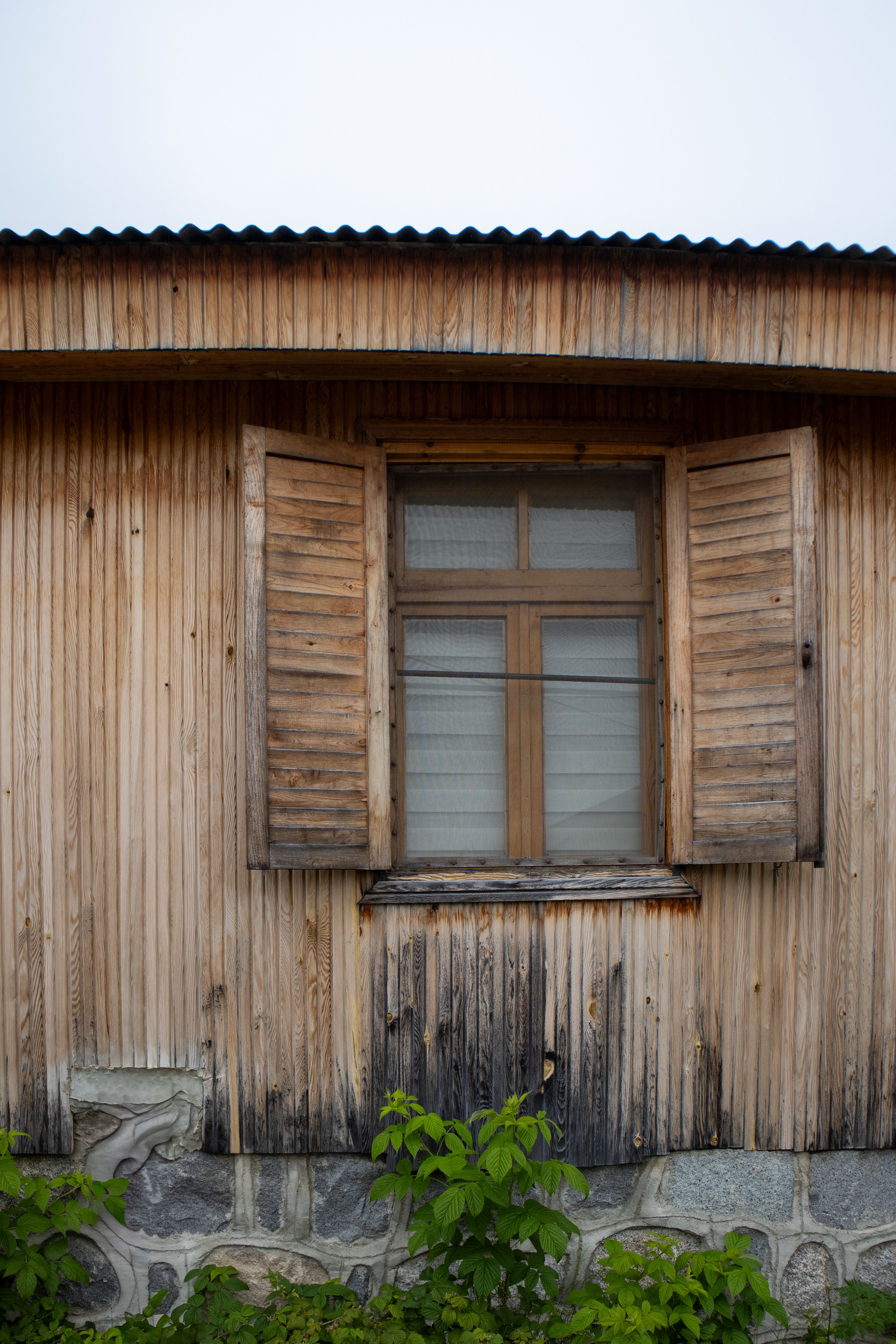 Charming rustic wooden house with closed shutters in Rize, Türkiye. Perfect for vintage home themes.